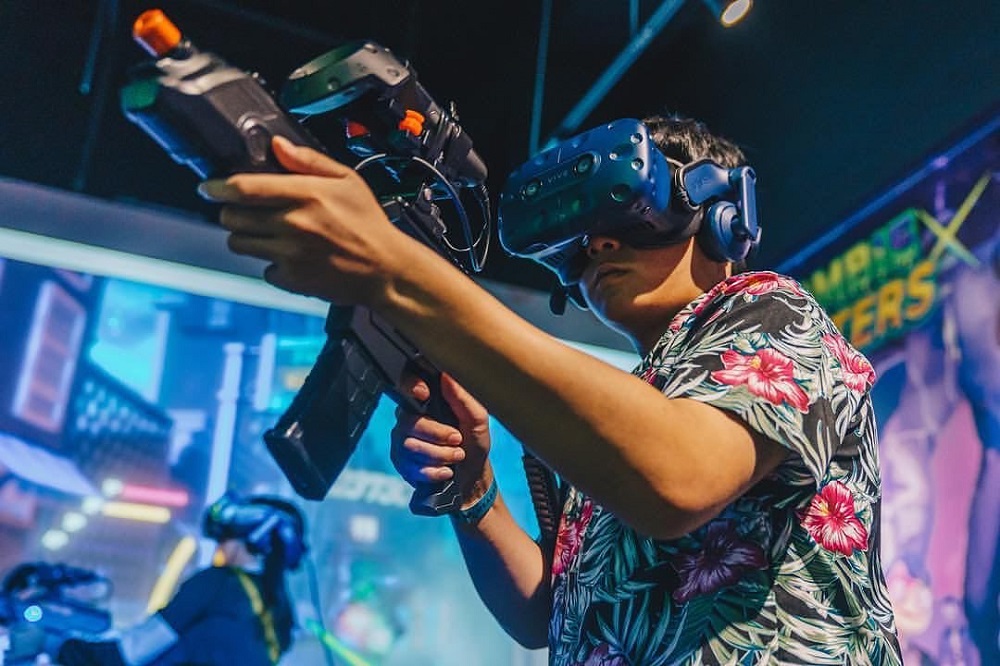 A man with a virtual reality headset and gun